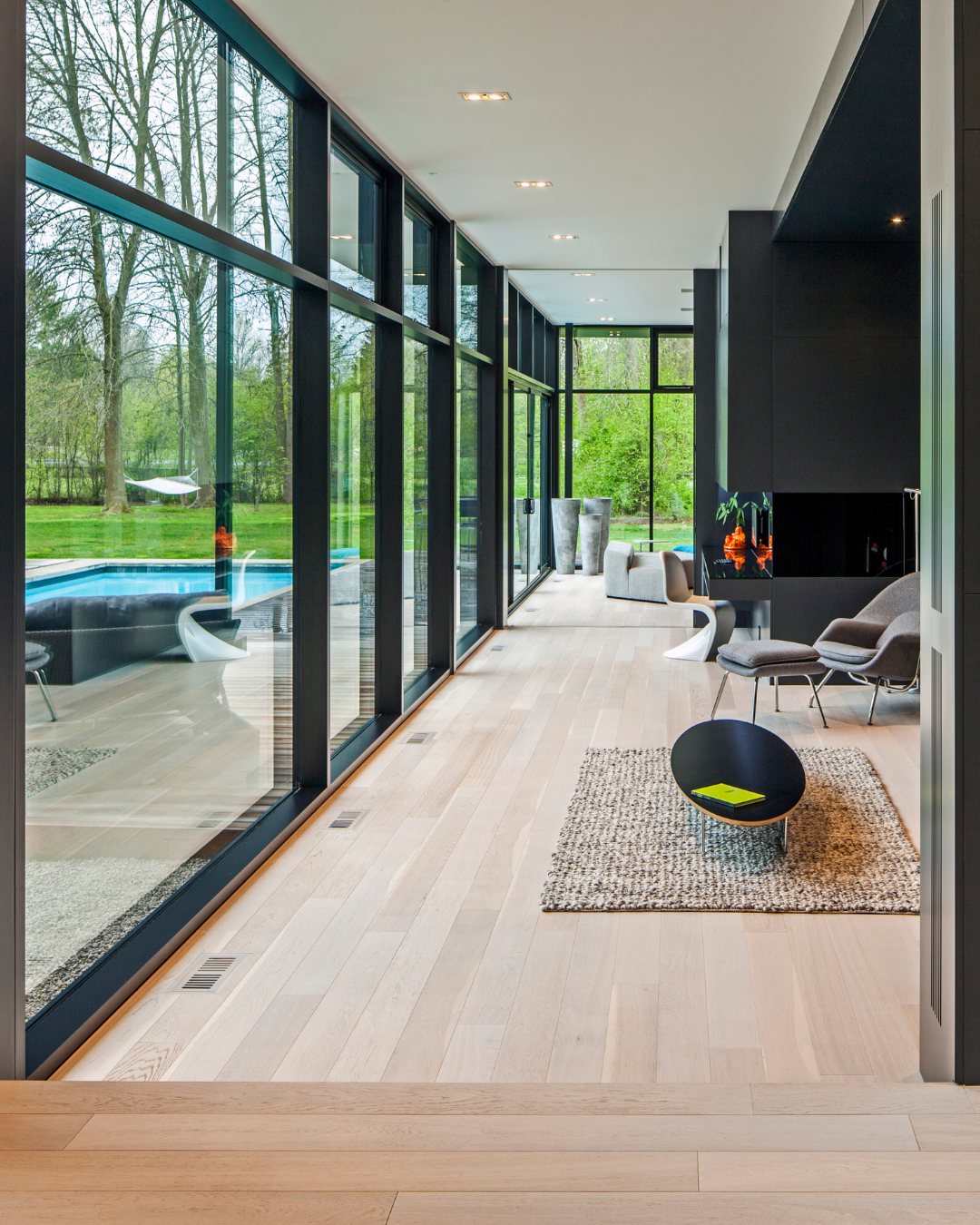 Memories of Scandinavia — light oak floor in a glass-walled modern home